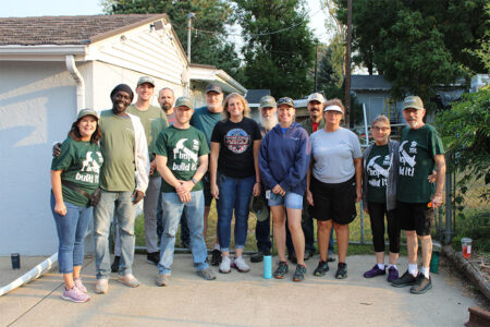 MasterBrand team members smile for a picture with homeowners Chuck (veteran) and JoAnn