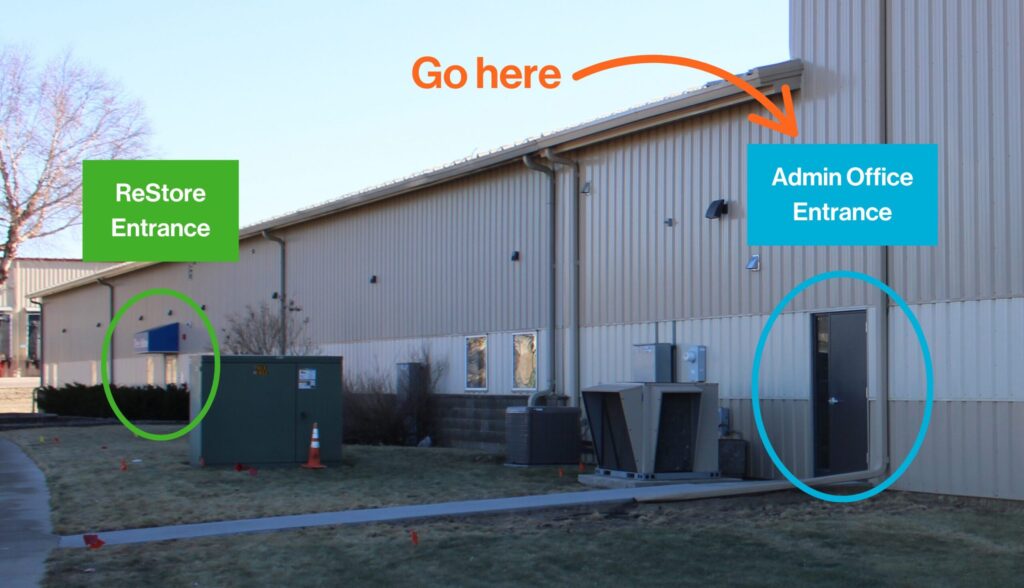 The outside of the Habitat building. The ReStore entrance is labeled in green on the left and the admin office entrance is labeled in blue on the right.