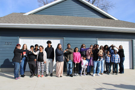 Habitat homebuyers and their families are presented keys by sponsor company representatives.