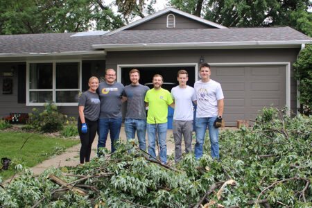 Volunteers from ISG help with branch cleanup after the July 2025 storms.