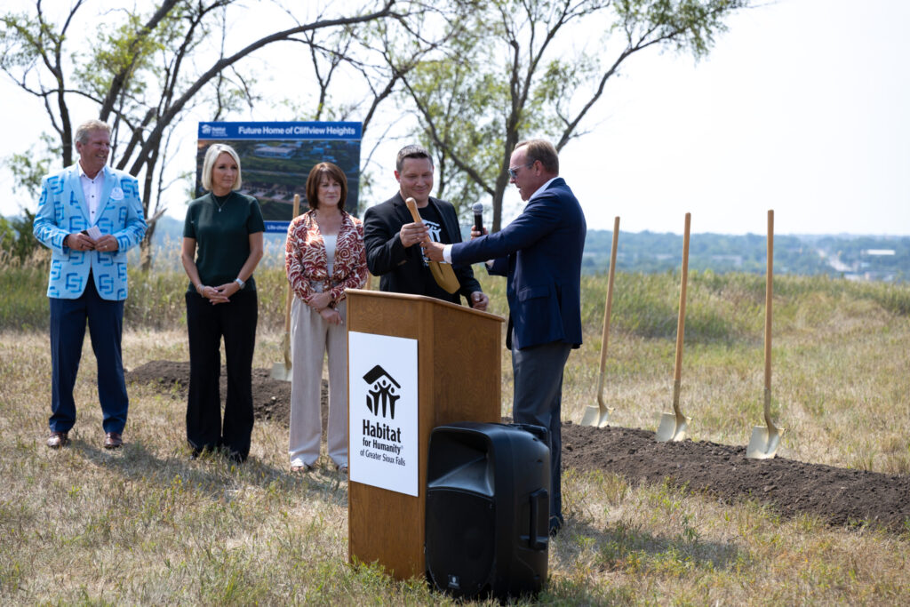 Sioux Falls Development Foundation Past Board Chair Kent Cutler presents Habitat for Humanity of Greater Sioux Falls Executive Director Rocky Welker with a commemorative shovel at the Cliffview Heights groundbreaking.