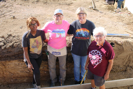 Habitat volunteers and a future homebuyer smile for a photo during Women Build 2025.