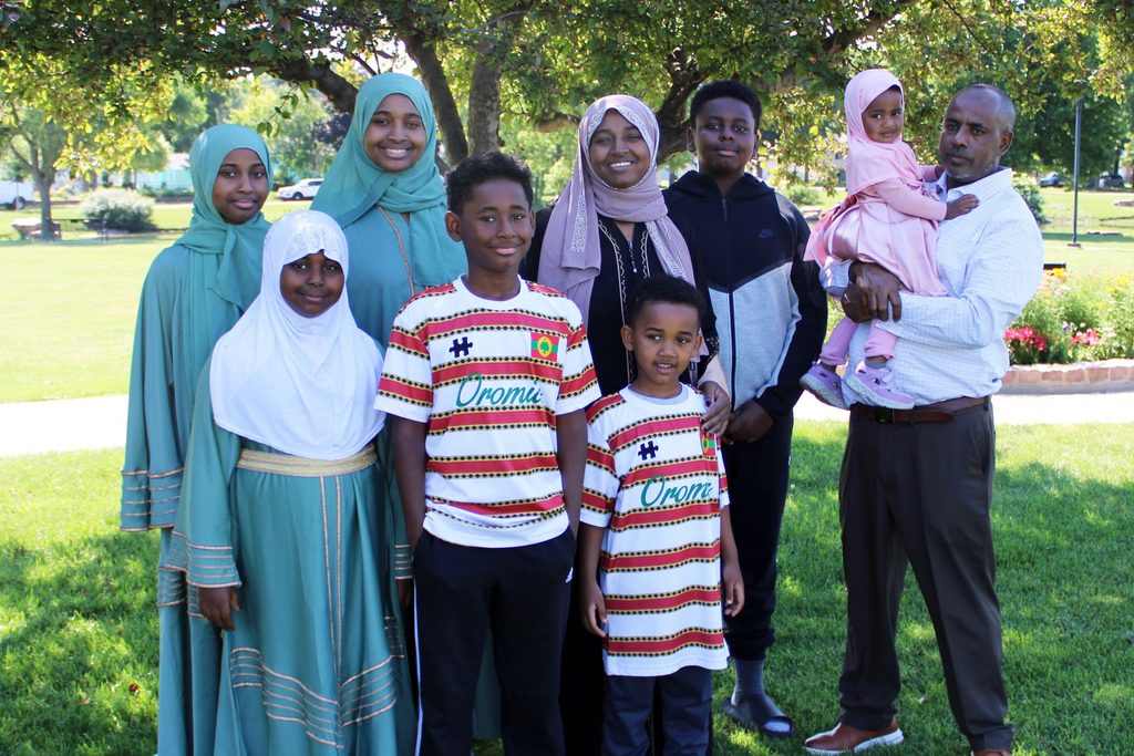 Family photo of Abdulkadir, Rahima and their seven children
