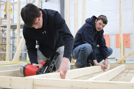 Students from Harrisburg High School build walls in their Habitat for Humanity home.
