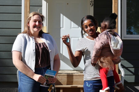 Adde smiles and holds up the key she received from Shannon Soukup with CNH Industrial
