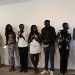Rebecca, her family and guests clap during the dedication.