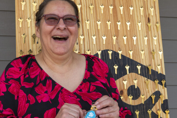 Vickie laughs with holding the keys to her new home.