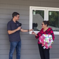 Kevin presents Vickie with a key to her home.