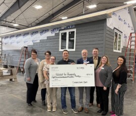 Thank you to Cornerstone Bank and Federal Home Loan Bank of Des Moines for awarding us an $8,750 Member Impact Fund grant! Rocky and the team from Cornerstone Bank smile in front of a Habitat home holding a giant check for $8,750.