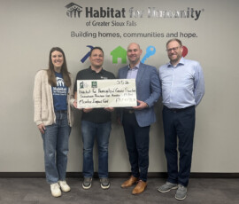 Thank you to First Bank & Trust and Federal Home Loan Bank of Des Moines for awarding us a $17,500 Member Impact Fund grant! Habitat for Humanity and First Bank & Trust team members smile while holding a giant check for $17,500.