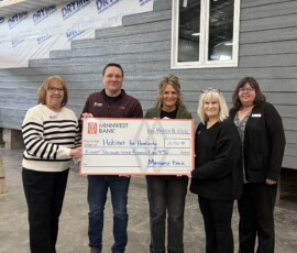 Thank you to Minnwest Bank and Federal Home Loan Bank of Des Moines for awarding us an $8,750 Member Impact Fund grant! Habitat for Humanity and Minnwest Bank team members smile while holding a giant check for $8,750.