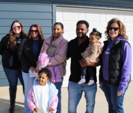 Thank you to Pathward and Federal Home Loan Bank of Des Moines for awarding us a $65,625 Member Impact Fund grant! Pathward team members smile with new Habitat homebuyers and their children at a home dedication.