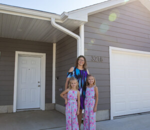 Dalonda and her daughters outside of their new Millard Acres twin home.
