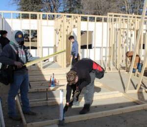 Southeast Technical College students build walls inside of a Millard Acres twin home.