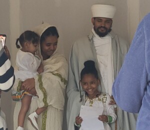 Efrem, Wadasse and their two children speak at their home dedication