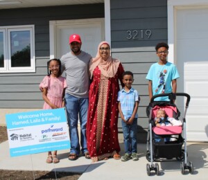 Hamed, Laila and their four children in front of their new Millard Acres home.
