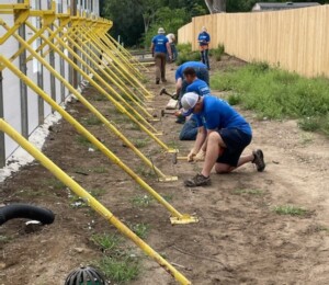 Volunteers hammer in stakes for the ICF supports.