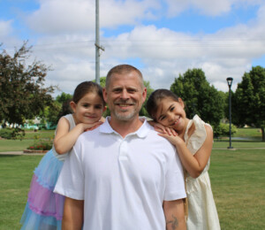 Family photo of future Millard Acres homebuyer Brian and his two daughters