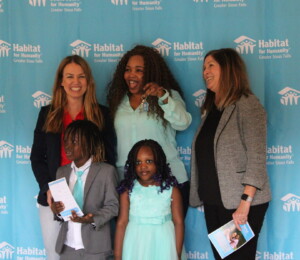Owrshalim smiles with the keys to her new Millard Acres home.