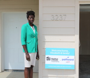 Elizabeth poses for a photo outside of her new home.