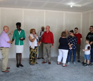 Three families receive keys to their new Millard Acres homes from sponsors.