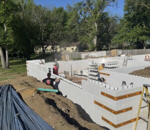 Habitat volunteers stack ICF block for a twin home basement.