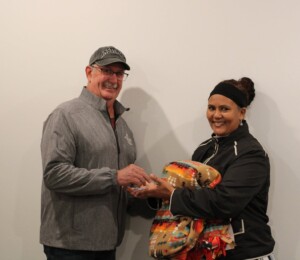 Netsenet smiles while receiving a key from a long-time Habitat supporter during her home dedication.