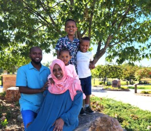 Family photo of future Millard Acres homebuyers Yimam, Sualiha and their three children